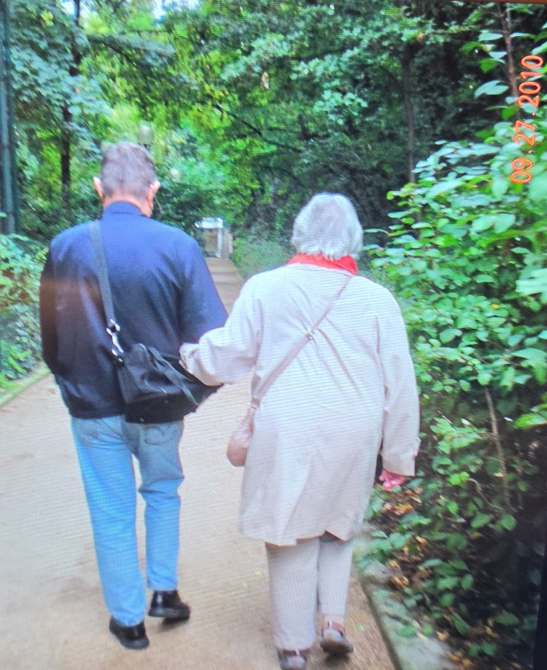 Cynthia Camille Miller Dyer walking arm in arm with Norman Hill Dyer along a wooded path, September 2010.